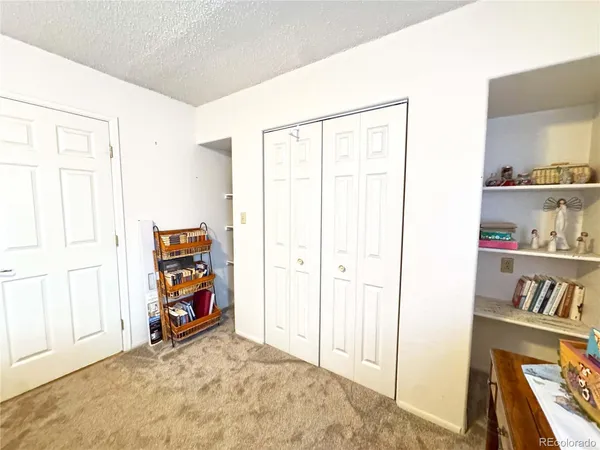a living room with furniture and a bookshelf
