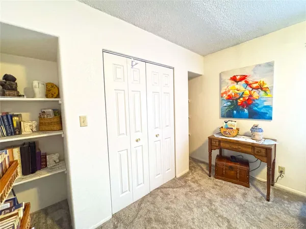 a bedroom with a bed and a book shelf