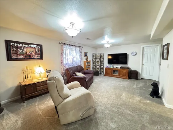 a spacious bedroom with a bed and flat screen tv