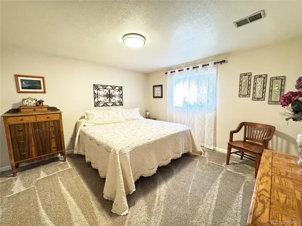 a bedroom with a bed and a book shelf