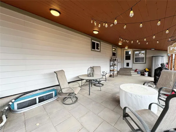 a view of a patio with chairs and tables