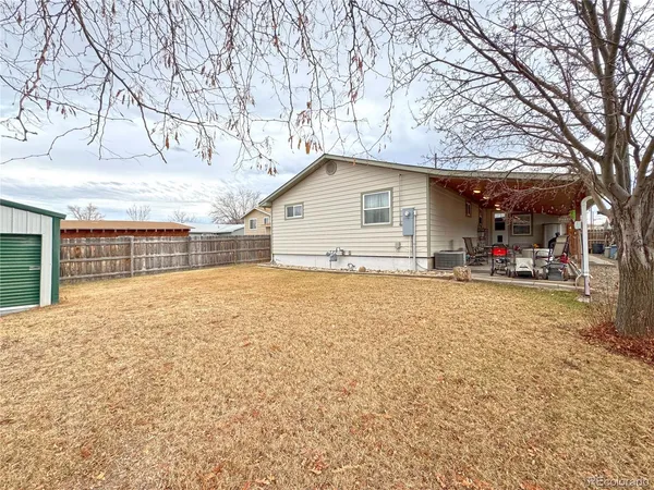 a view of a house with a yard covered with snow