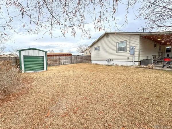 a view of a house with a yard covered with snow