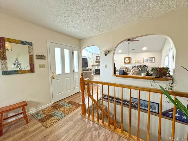 a view of a living room with furniture and wooden floor