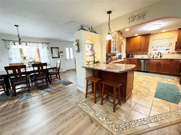 a dining area with furniture window and wooden floor