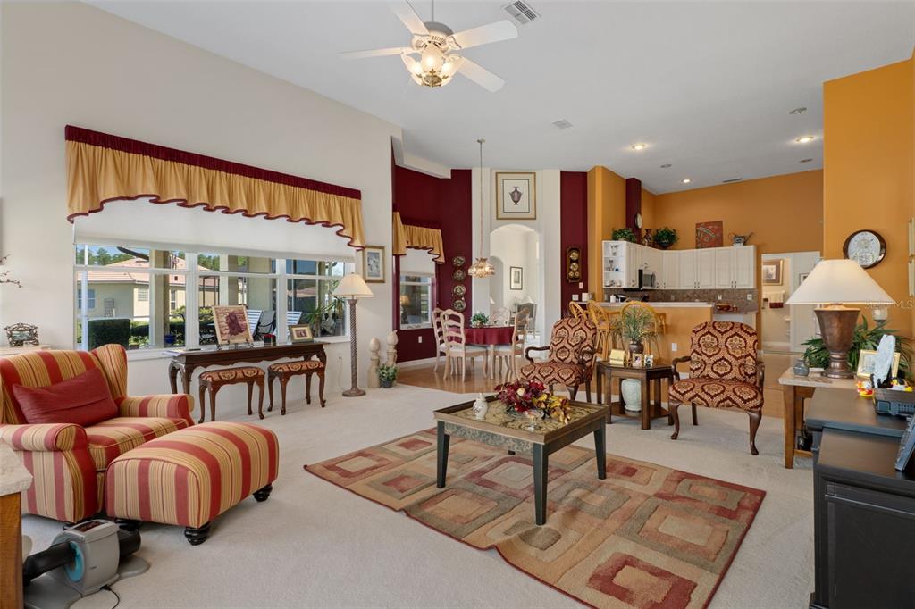 10081 Georgetown Court Weeki Wachee, FL 34613 - Photo 14 of 76 a living room with furniture a chandelier and a large window