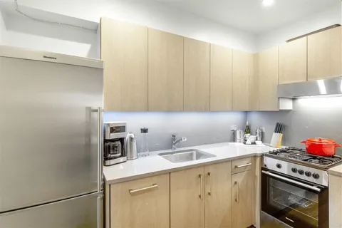 a kitchen with a sink cabinets and appliances
