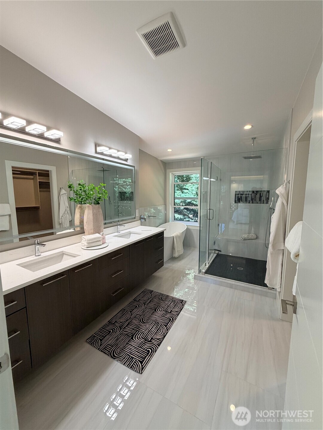 4305 Northeast 26th Court Renton, WA 98059 - Photo 30 of 40 a large bathroom with a large mirror vanity and a shower