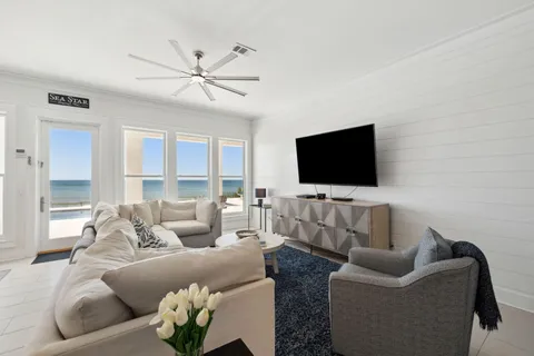 a bedroom with a bed and a flat tv screen on the dresser