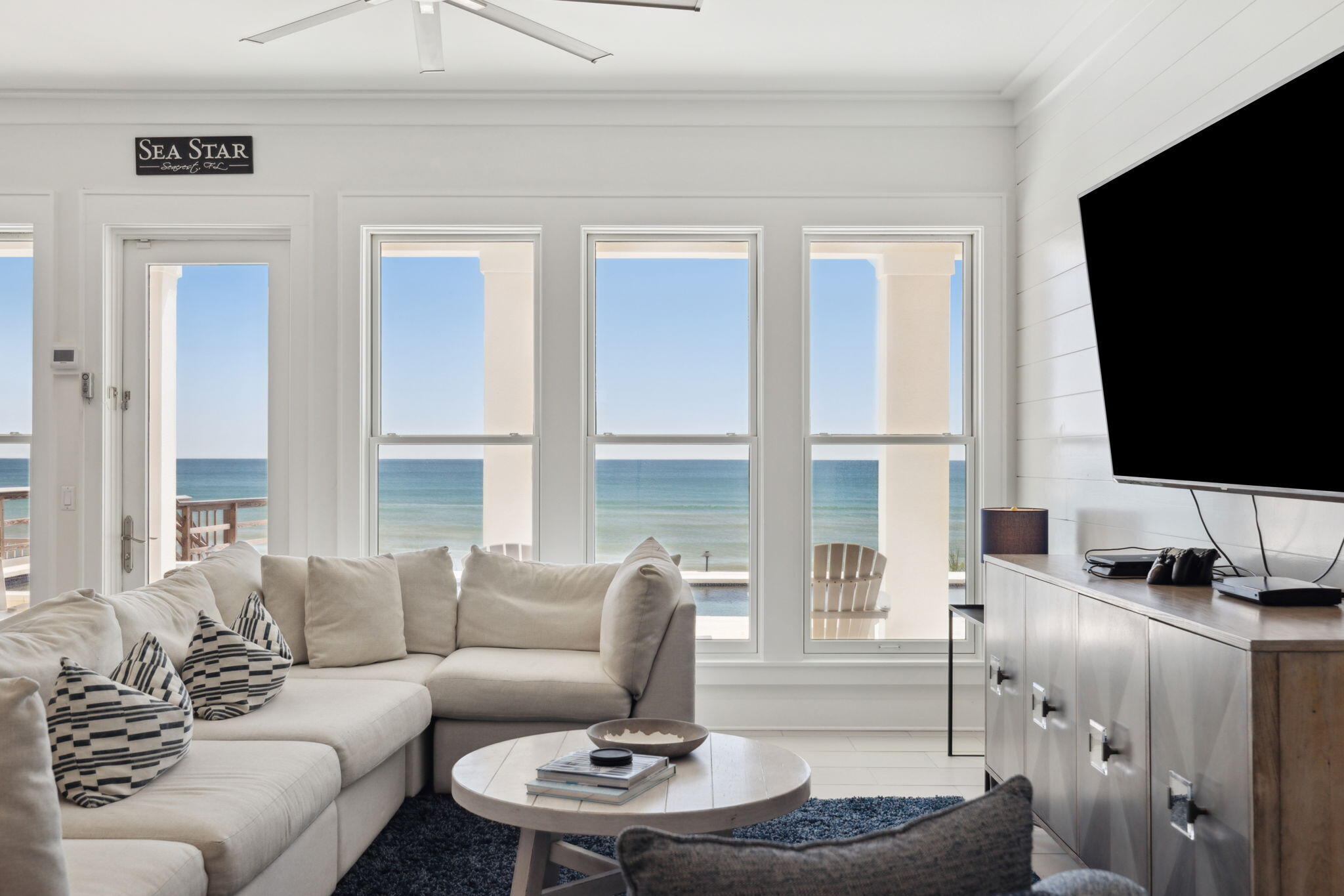 8266 East County Highway 30A Seacrest, FL 32461 - Photo 13 of 148 a living room with fireplace furniture and a flat screen tv