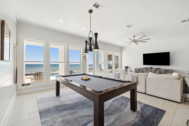 a living room with furniture a flat screen tv and a large window