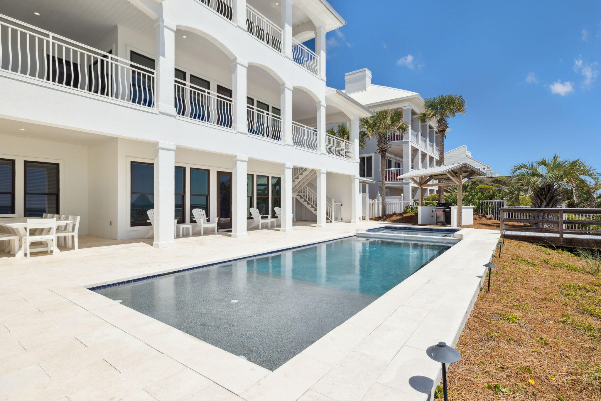 8266 East County Highway 30A Seacrest, FL 32461 - Photo 27 of 148 a view of a swimming pool with a lounge chairs