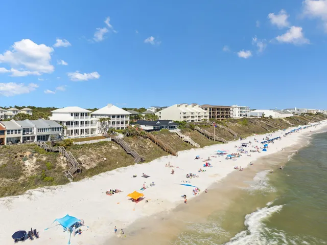 a living room with furniture a flat screen tv and a large window