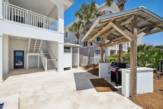 a living room with furniture and floor to ceiling windows