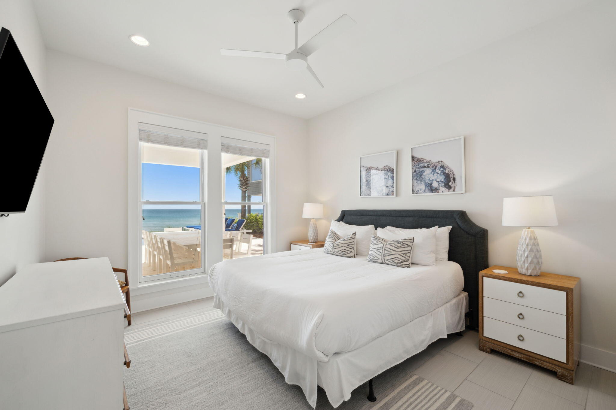 8266 East County Highway 30A Seacrest, FL 32461 - Photo 35 of 148 a bedroom with a bed and a flat tv screen on the dresser