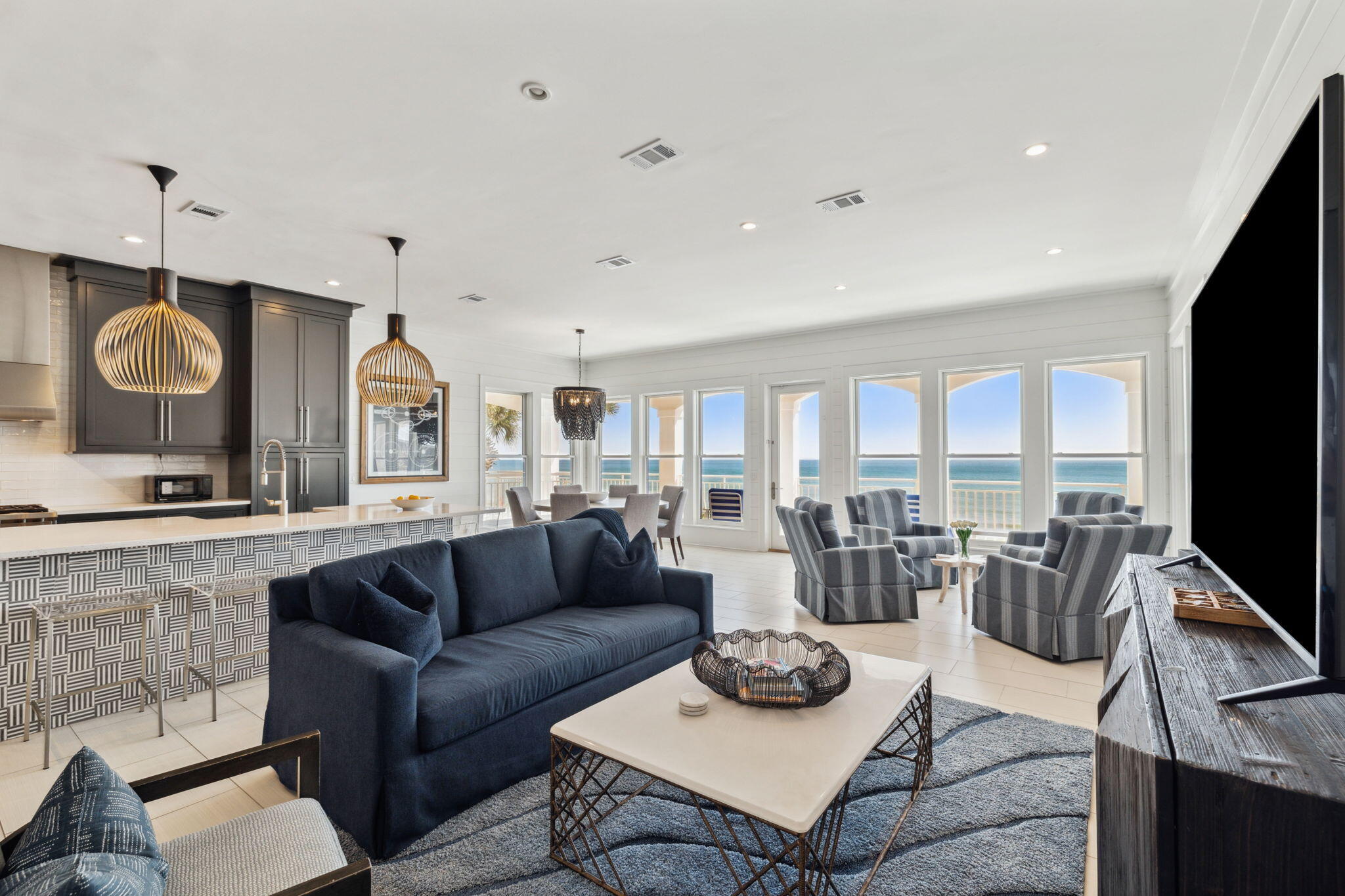 8266 East County Highway 30A Seacrest, FL 32461 - Photo 52 of 148 a living room with furniture a flat screen tv and a large window