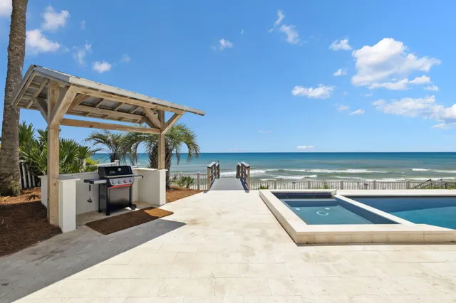 a view of a swimming pool with an outdoor seating