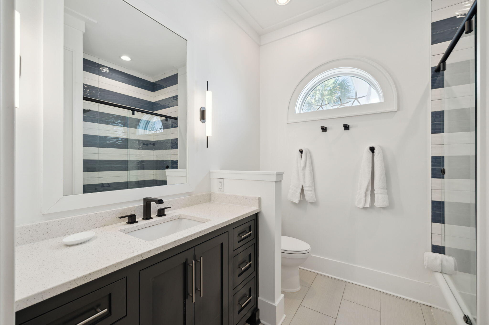 8266 East County Highway 30A Seacrest, FL 32461 - Photo 94 of 148 a bathroom with a double vanity sink toilet and shower