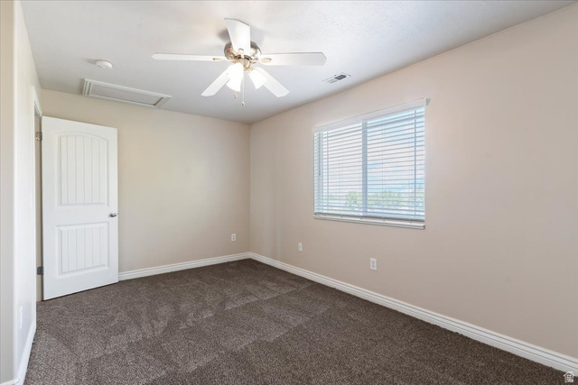 2350 South Highway 89, Unit 4 Perry, UT 84302 - Photo 28 of 30 Spare room with a ceiling fan and dark carpet