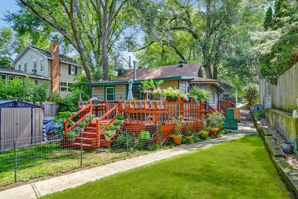 a view of a house with backyard and sitting area