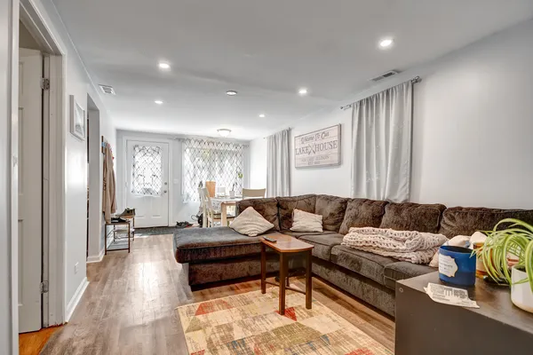 a living room with furniture and wooden floor
