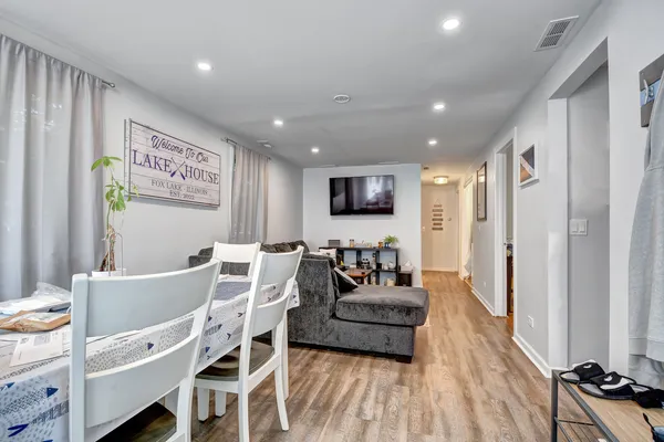 a living room with furniture a flat screen tv and a table