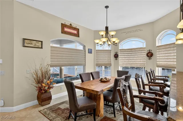 a view of a dining room with furniture and chandelier
