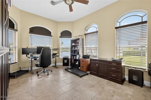 a view of a livingroom with workspace and a window