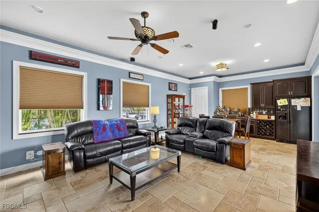 a living room with furniture ceiling fan and a window