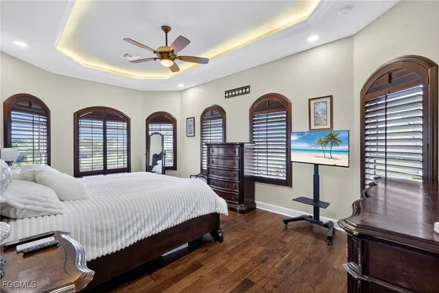 a bedroom with a large bed and a chandelier