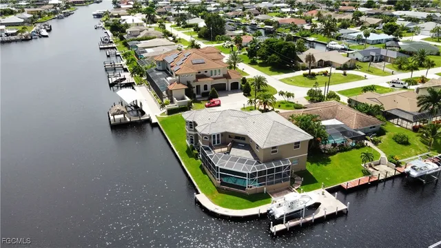 an aerial view of a swimming pool a yard and lake view