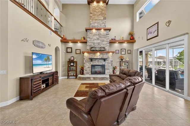 a living room with furniture fireplace and flat screen tv