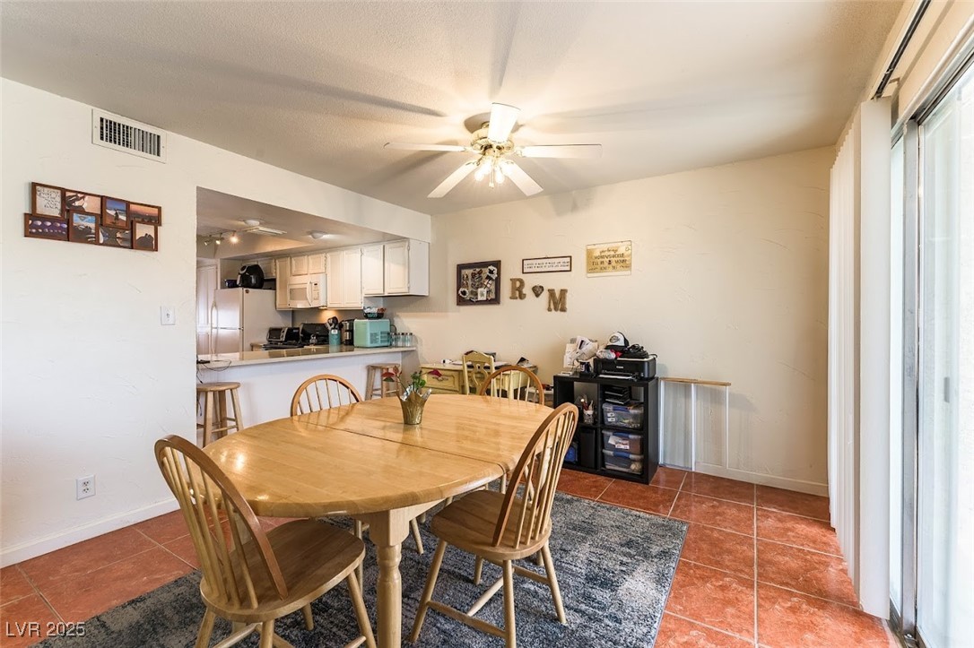 555 Rene Lane Henderson, NV 89015 - Photo 9 of 28 Tiled dining room with ceiling fan, baseboards, and visible vents
