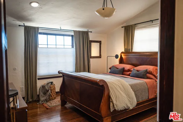 a bedroom with furniture and a flat screen tv
