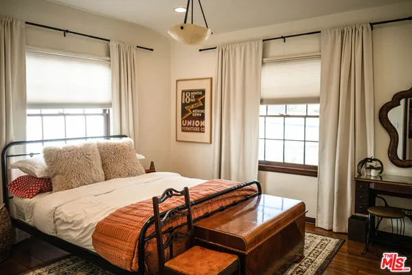 a bedroom with bed and window