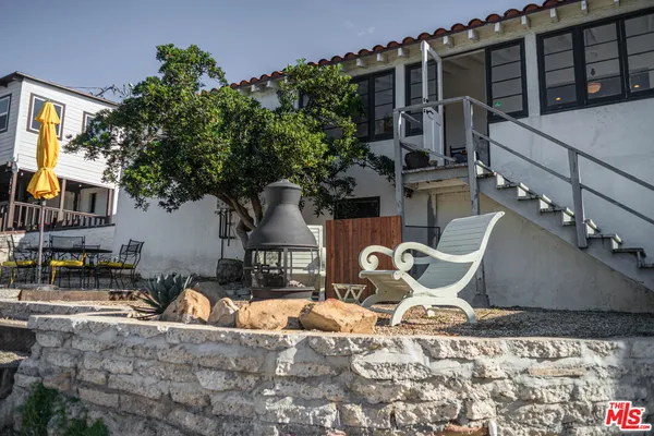 a wooden bench sitting in front of a house