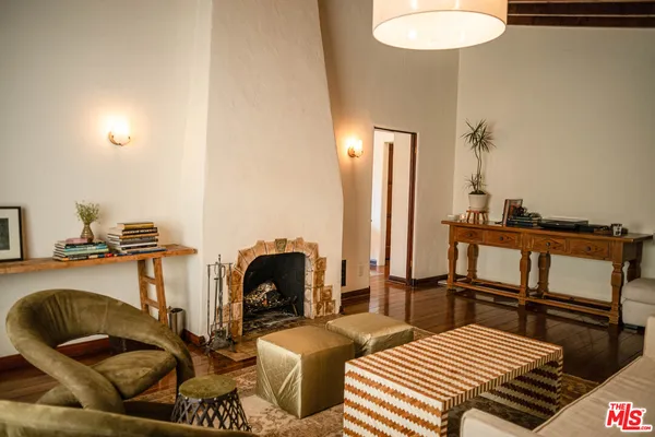 a bedroom with furniture and a wooden floor