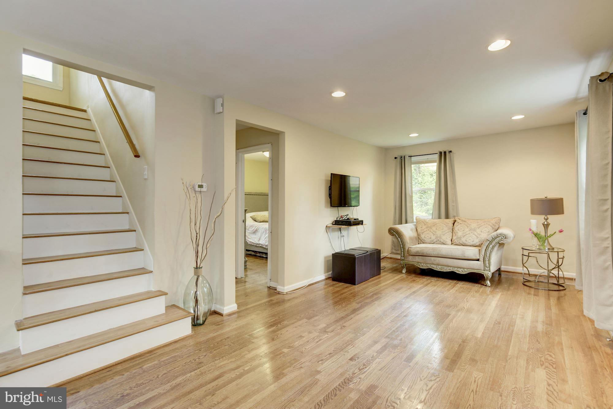 11601 Mapleview Drive Silver Spring, MD 20902 - Photo 2 of 23 a living room with furniture and a wooden floor