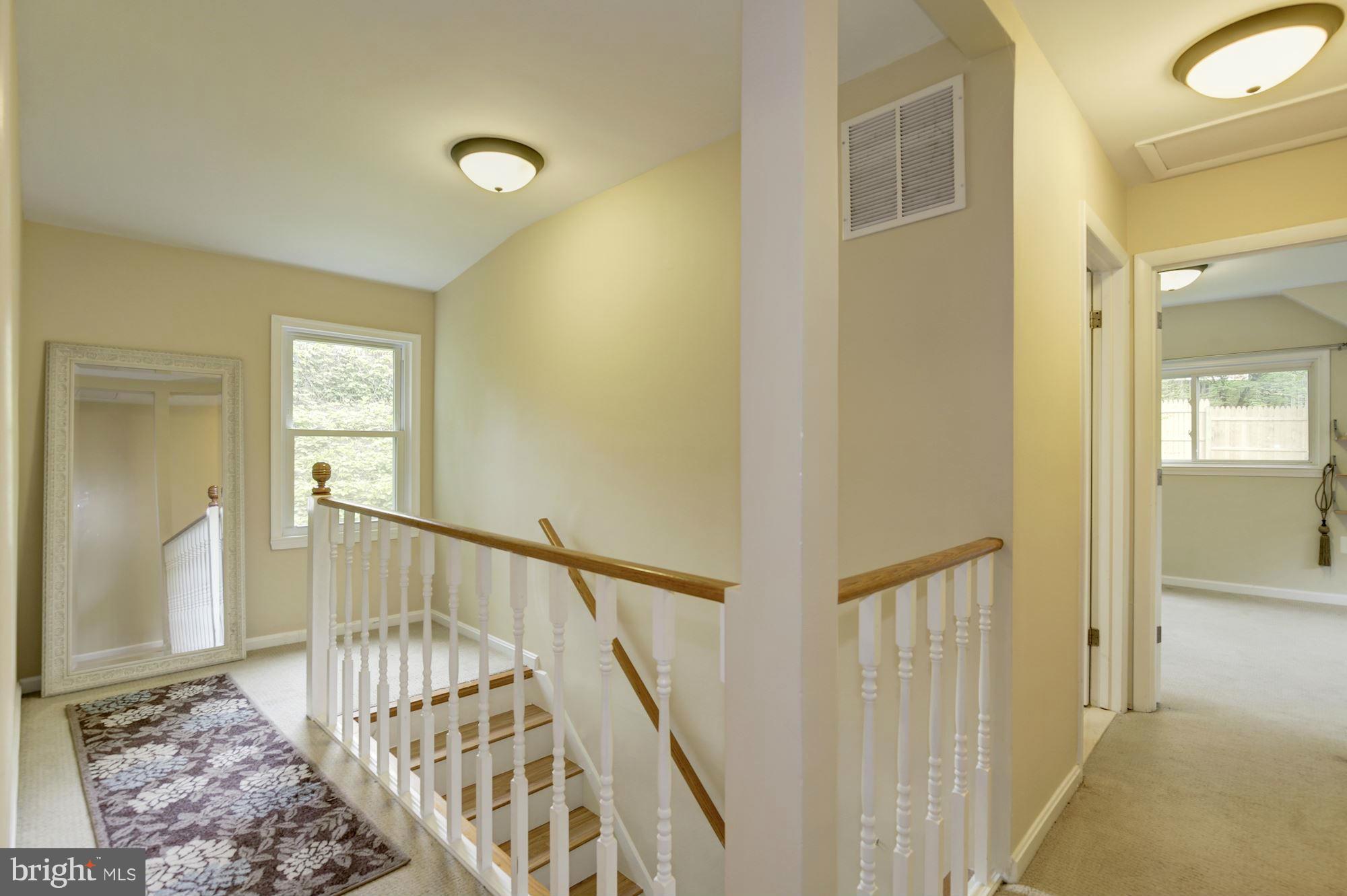 11601 Mapleview Drive Silver Spring, MD 20902 - Photo 12 of 23 a view of a hallway with wooden floor and stairs