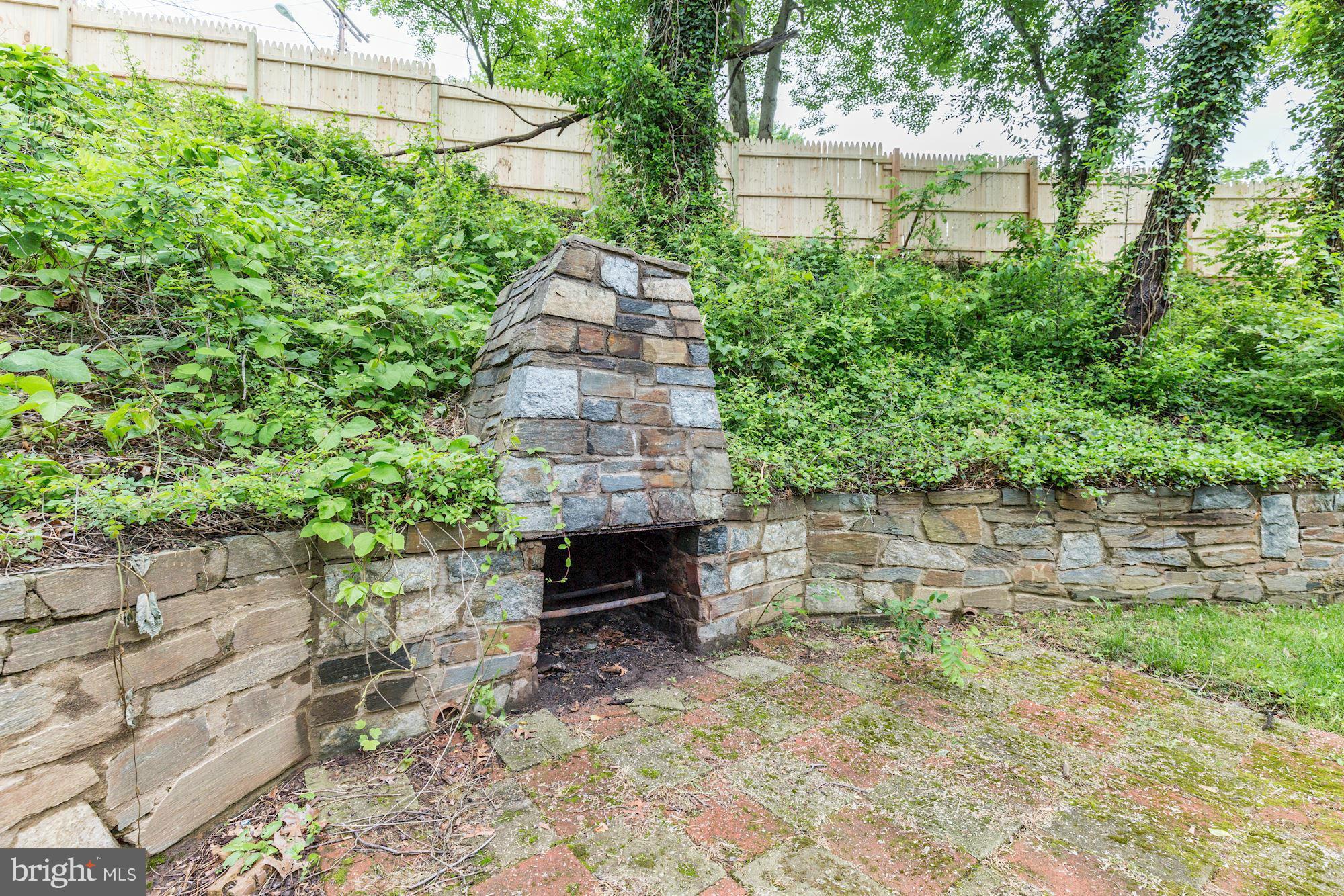 11601 Mapleview Drive Silver Spring, MD 20902 - Photo 20 of 23 a backyard of a house with large trees and plants