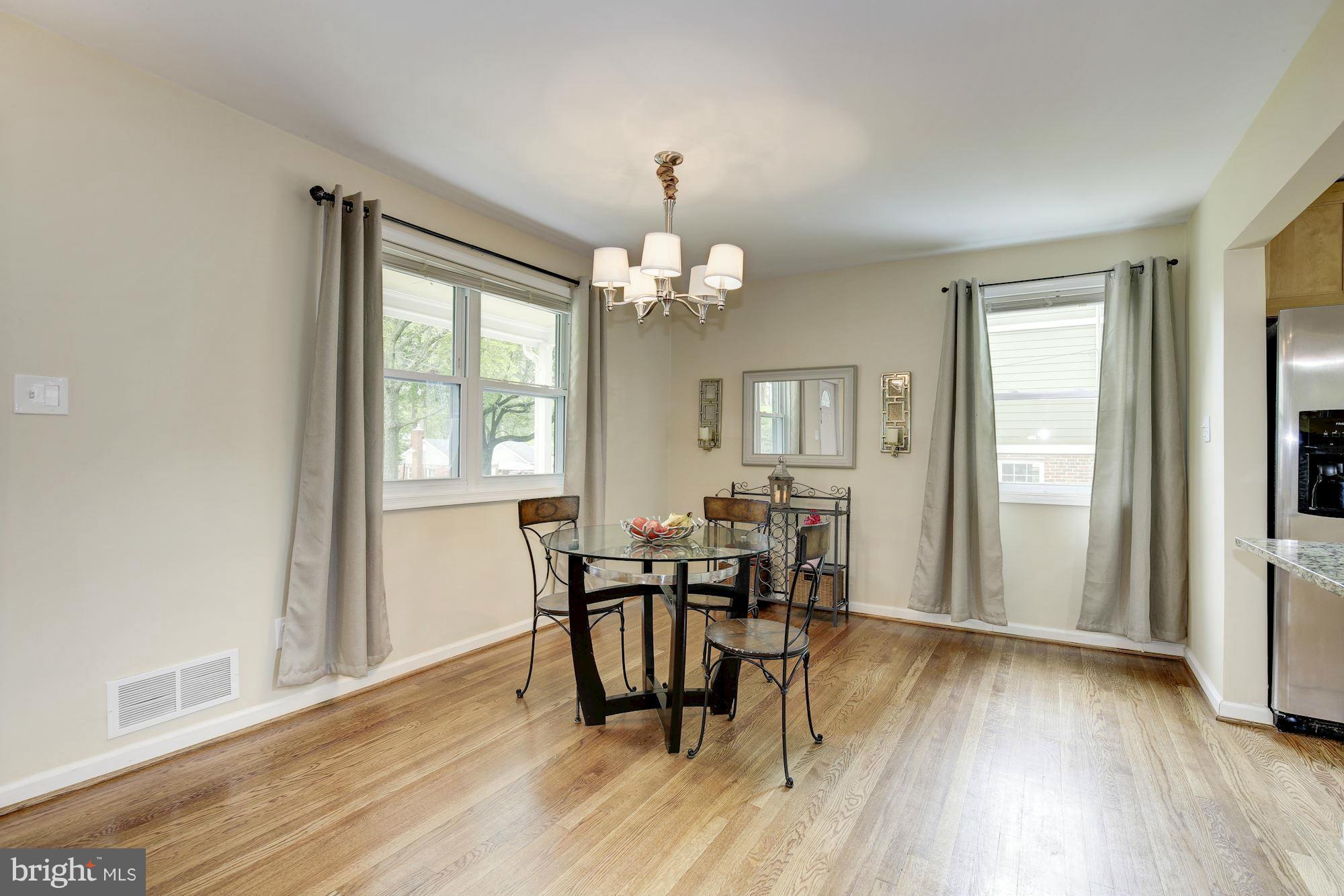11601 Mapleview Drive Silver Spring, MD 20902 - Photo 3 of 23 a view of a dining room with furniture and wooden floor
