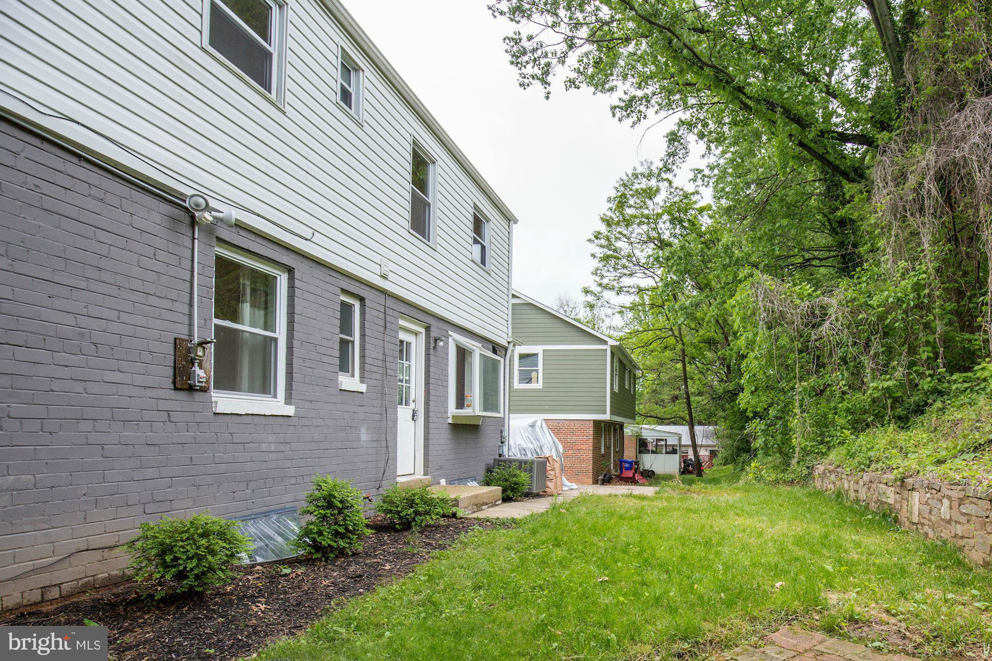 11601 Mapleview Drive Silver Spring, MD 20902 - Photo 21 of 23 a front view of a house with a yard and trees