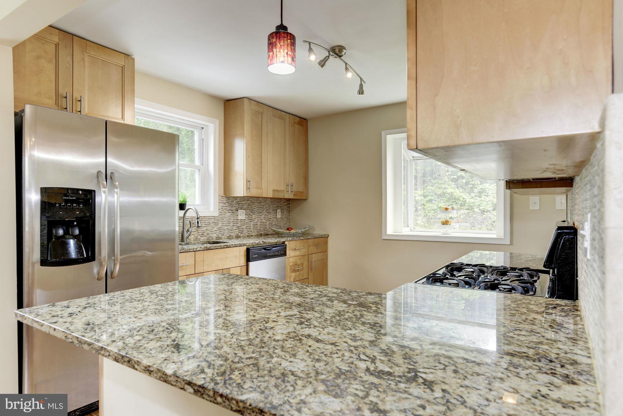 11601 Mapleview Drive Silver Spring, MD 20902 - Photo 4 of 23 a kitchen with stainless steel appliances granite countertop a sink stove and refrigerator