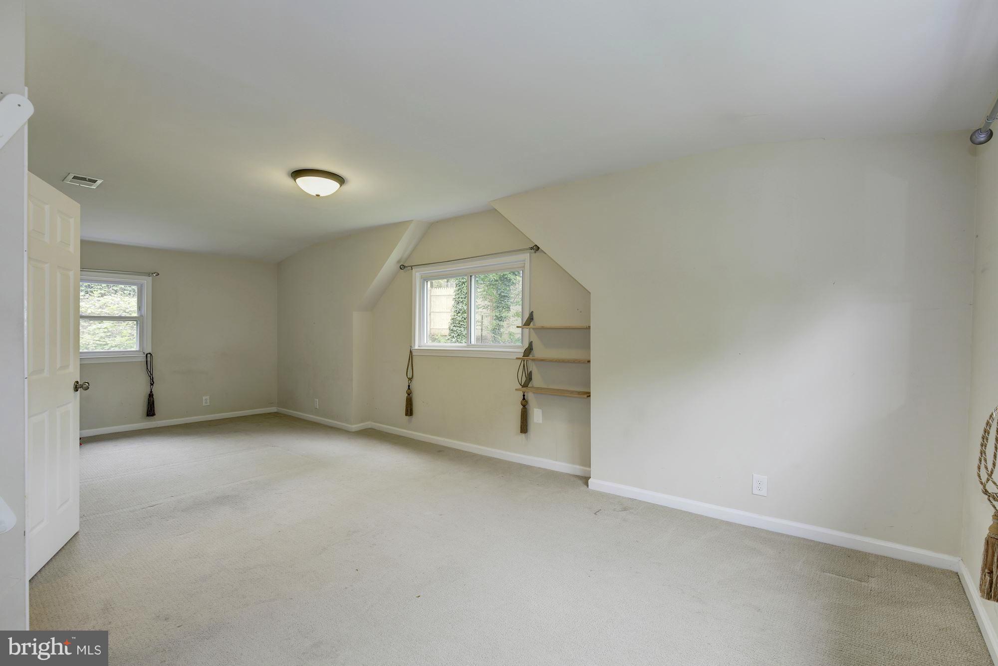 11601 Mapleview Drive Silver Spring, MD 20902 - Photo 7 of 23 an empty room with windows and mirror