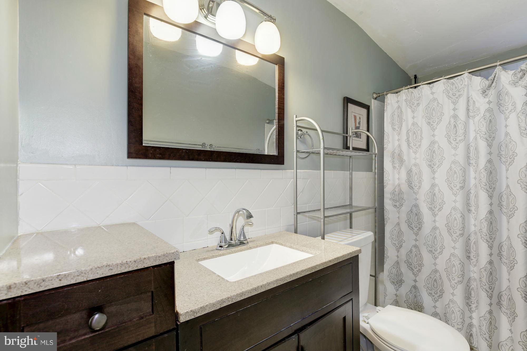 11601 Mapleview Drive Silver Spring, MD 20902 - Photo 9 of 23 a bathroom with a sink mirror and toilet