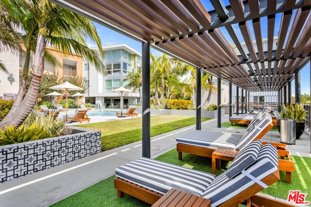 12760 Millennium Drive, Unit NA411 Los Angeles, CA 90094 - Photo 11 of 34 a view of a patio with a table and chairs