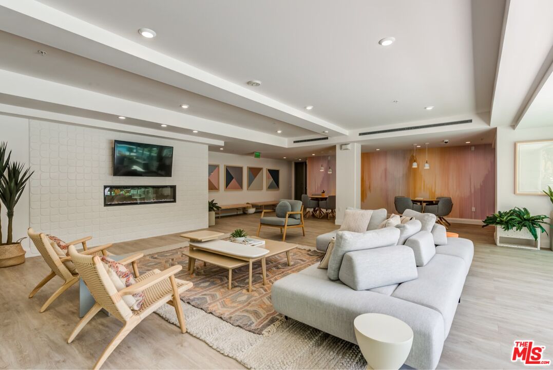 12760 Millennium Drive, Unit NA411 Los Angeles, CA 90094 - Photo 32 of 34 a living room with furniture and a wooden floor