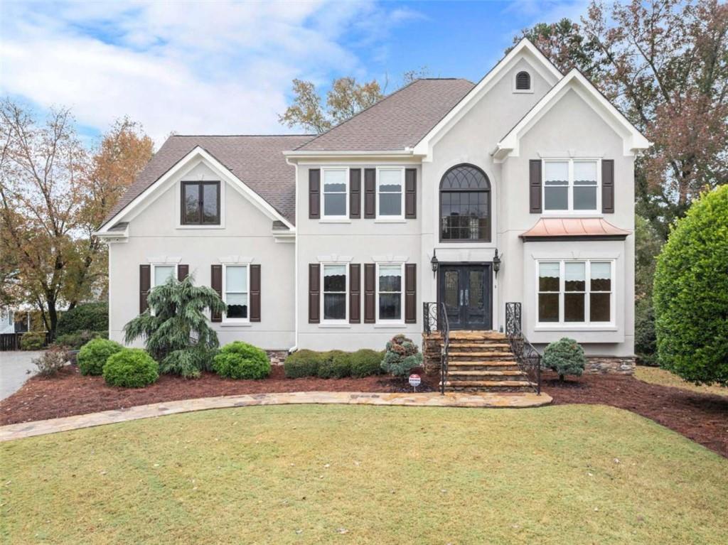 a front view of a house with a yard
