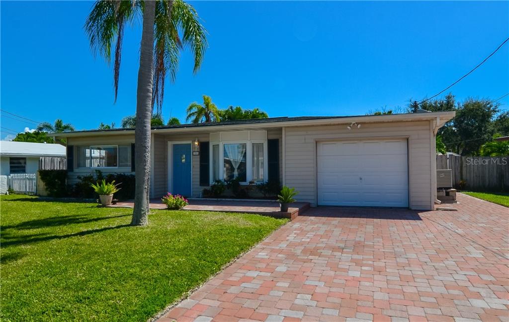 751 Pruitt Drive Madeira Beach, FL 33708 - Photo 1 of 1 a front view of a house with a garden and yard