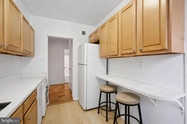 a kitchen with stainless steel appliances granite countertop a refrigerator and microwave
